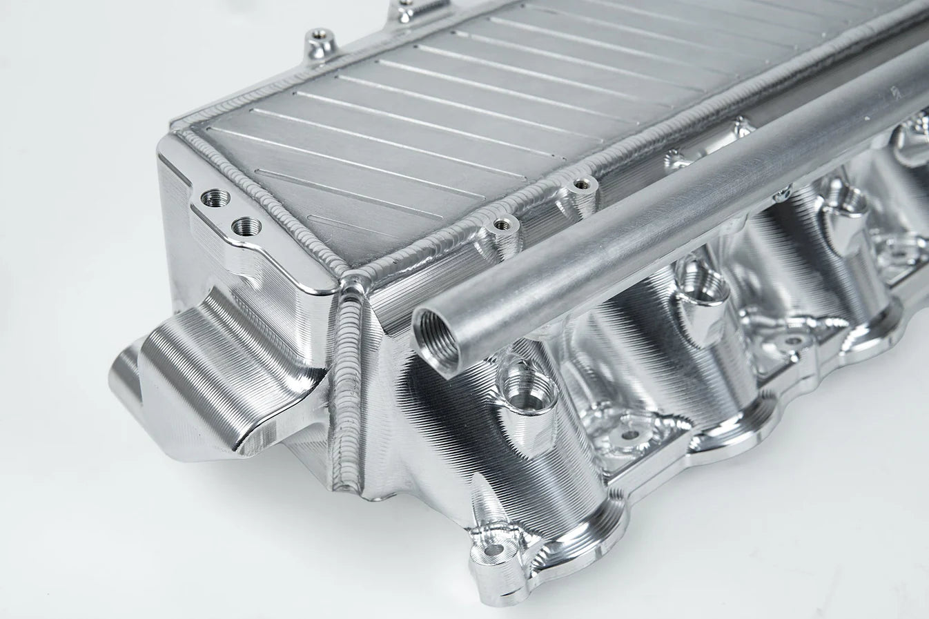 Charge-air cooler manifold, silver finned heat exchanger with curved coolant pipes and ports
