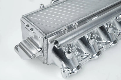 Charge-air cooler manifold, silver finned heat exchanger with curved coolant pipes and ports