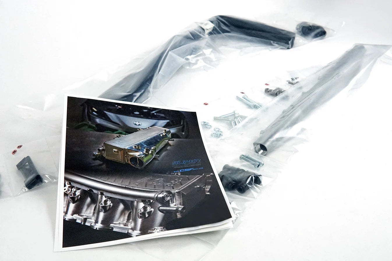Charge-air cooler manifold kit parts in clear bag inside labeled box