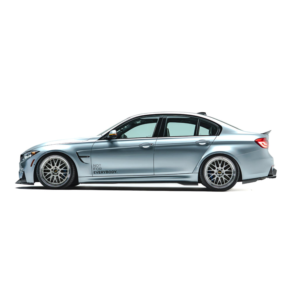 BMW front bumper lip spoiler in dark carbon fiber, side view with front section