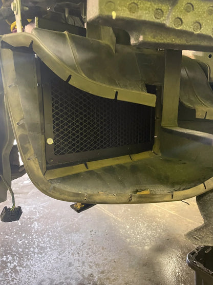 Auxiliary radiator mounted inside front bumper opening, black mesh core