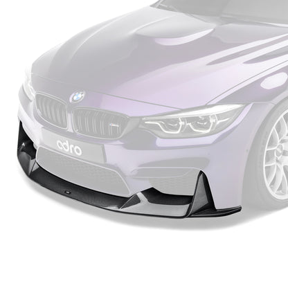 Carbon fiber front lip spoiler on BMW front bumper, close-up on white car