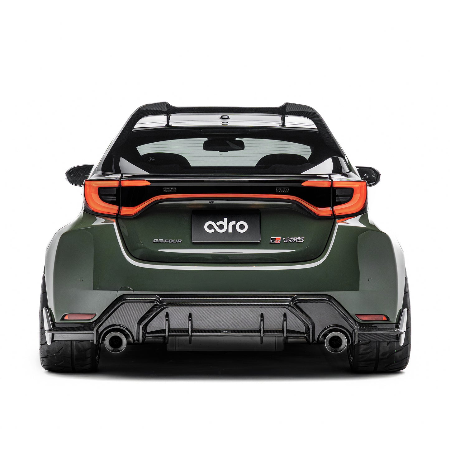 ADRO carbon fiber rear diffuser on Toyota GR Yaris, rear view showing wide fenders and tinted windows.
