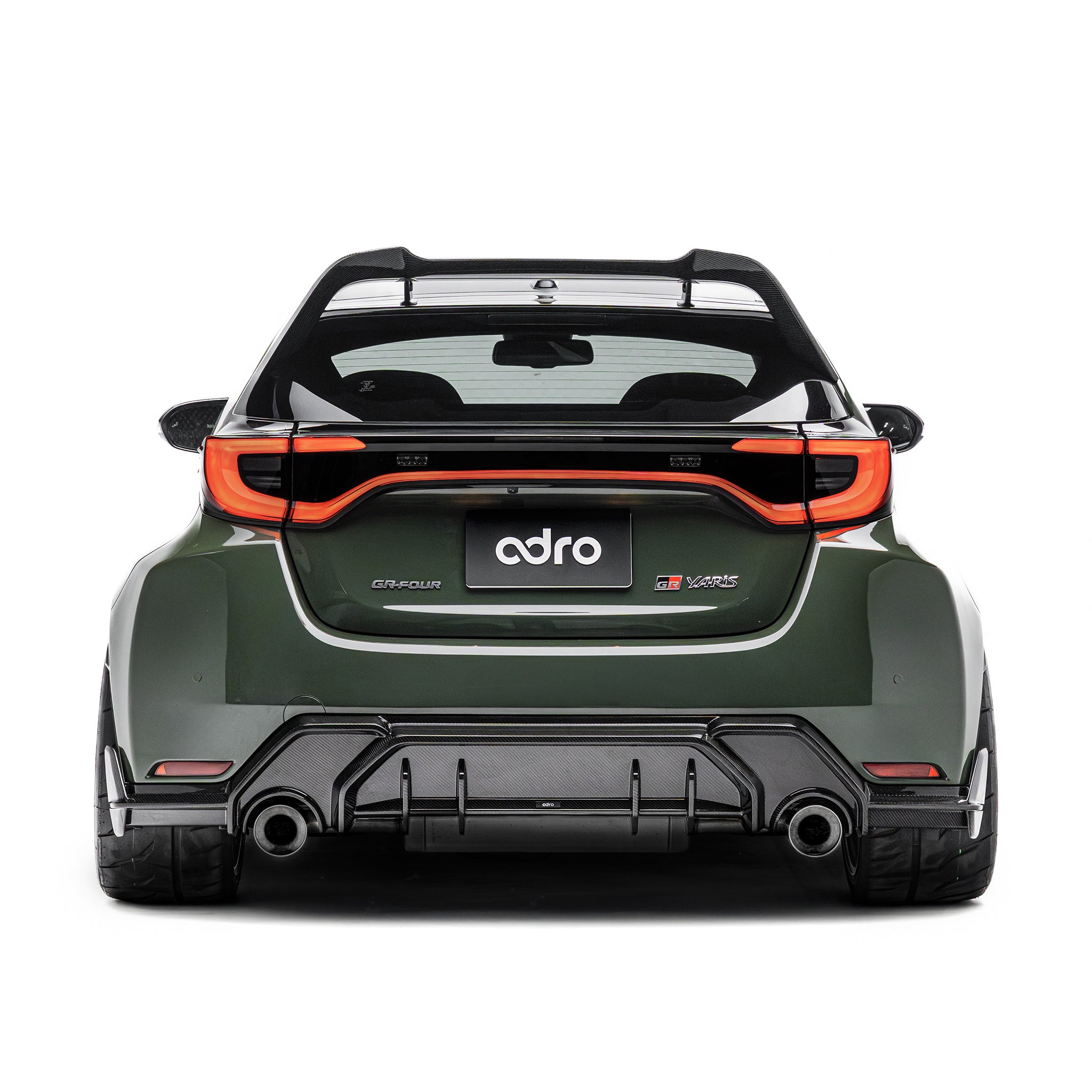 ADRO carbon fiber rear diffuser on Toyota GR Yaris, rear view showing wide fenders and tinted windows.