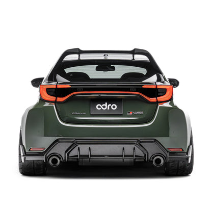 ADRO carbon fiber rear diffuser on Toyota GR Yaris, rear view showing wide fenders and tinted windows.
