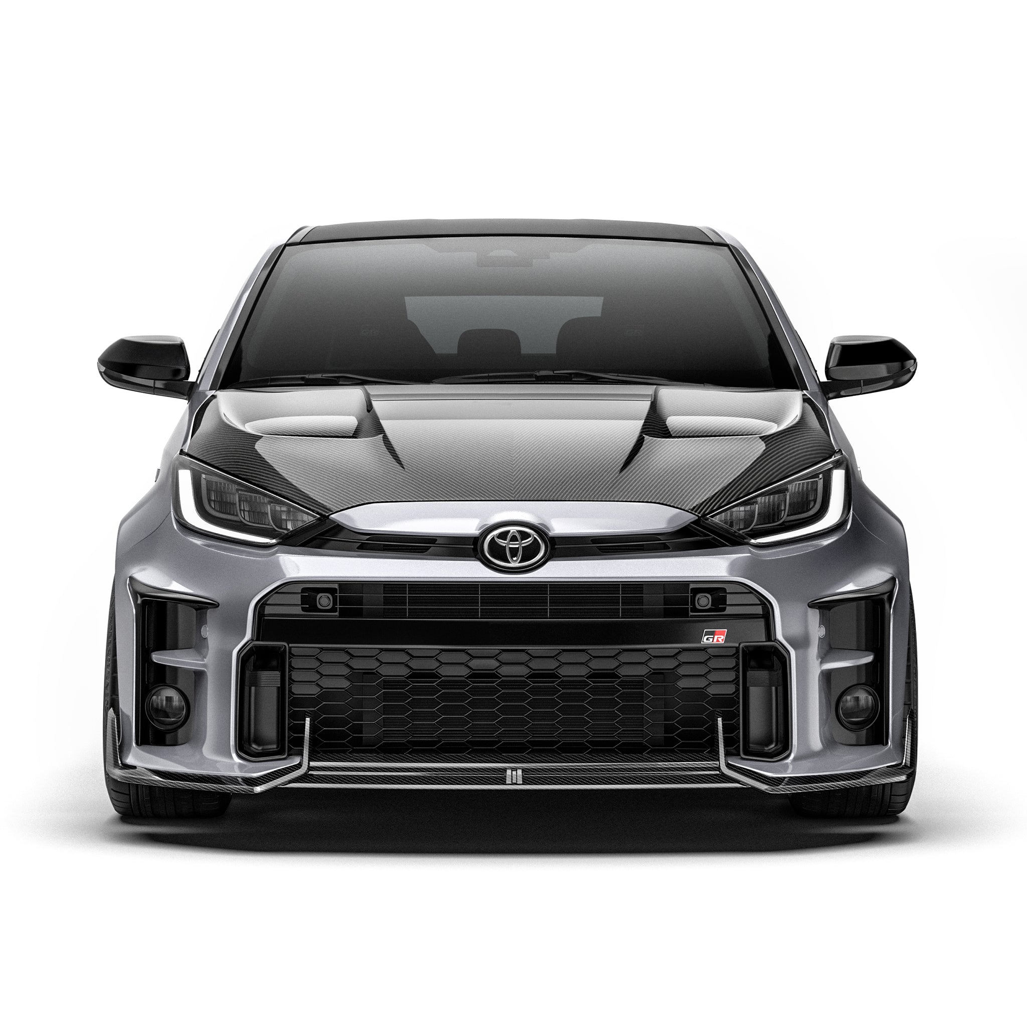 Carbon fiber front lip with dark woven pattern, attached along the lower front bumper.