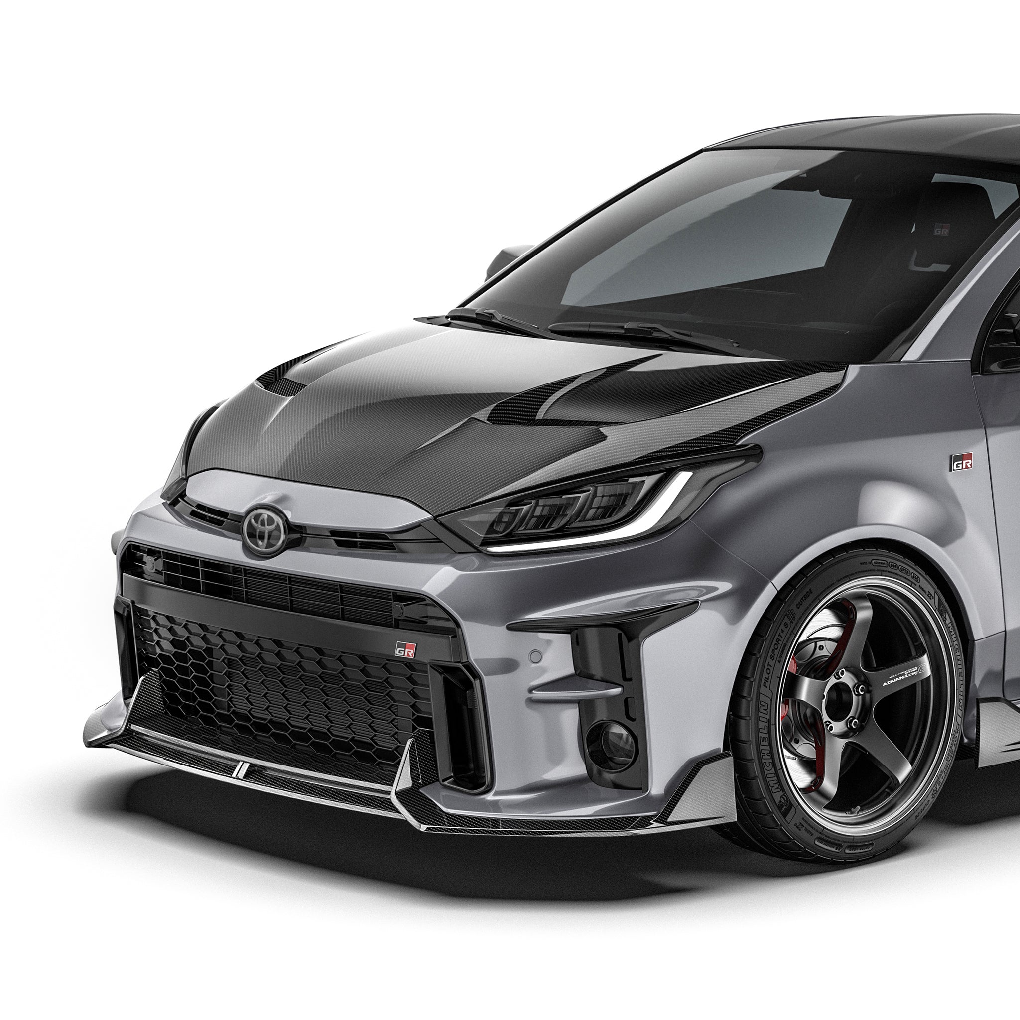 Carbon fiber front lip, dark woven finish, integrated with the lower front bumper.