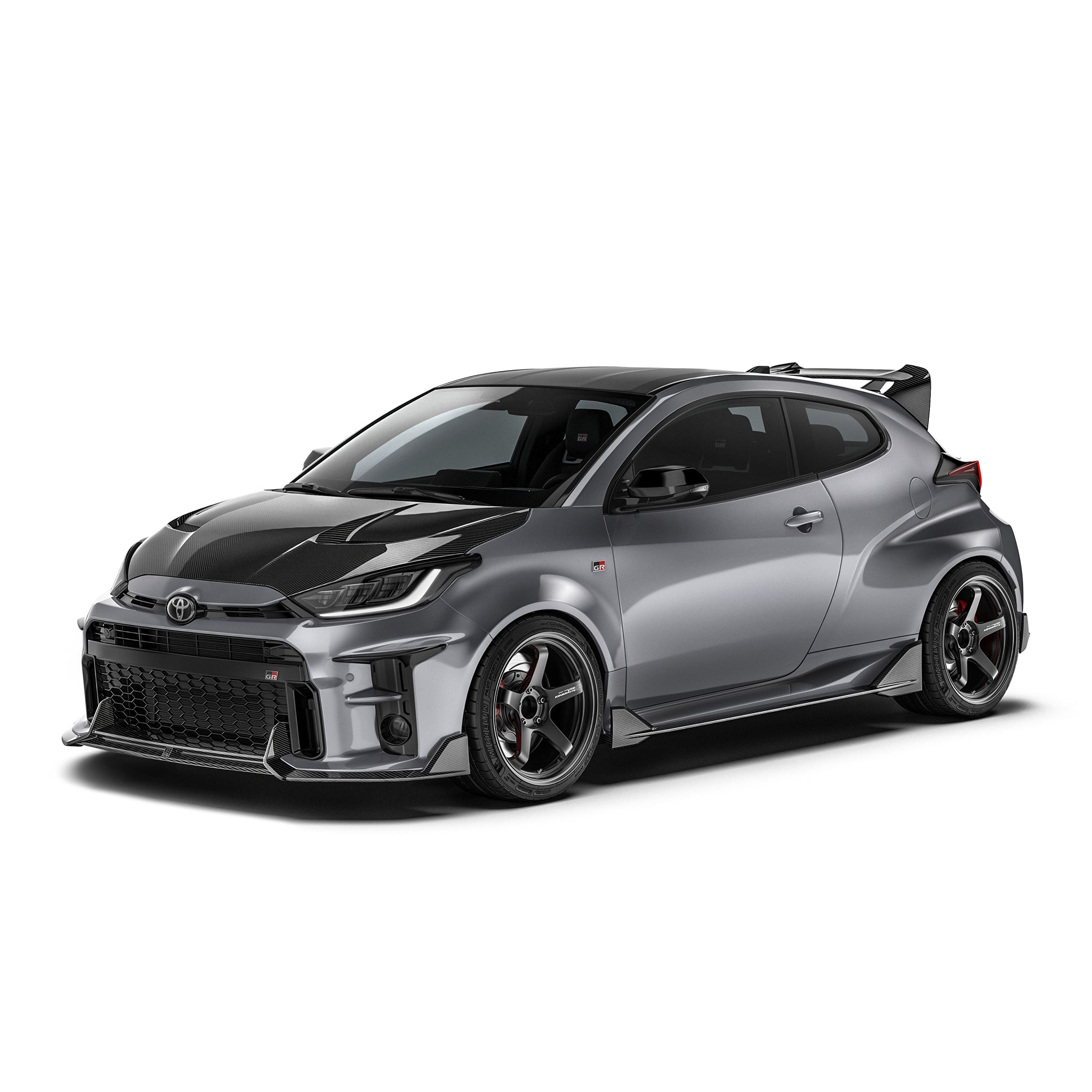 Carbon fiber front lip with dark texture, extending from the lower front bumper corners.