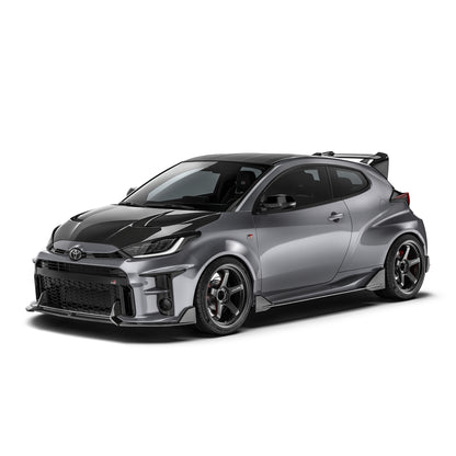 Carbon fiber front lip with dark texture, extending from the lower front bumper corners.