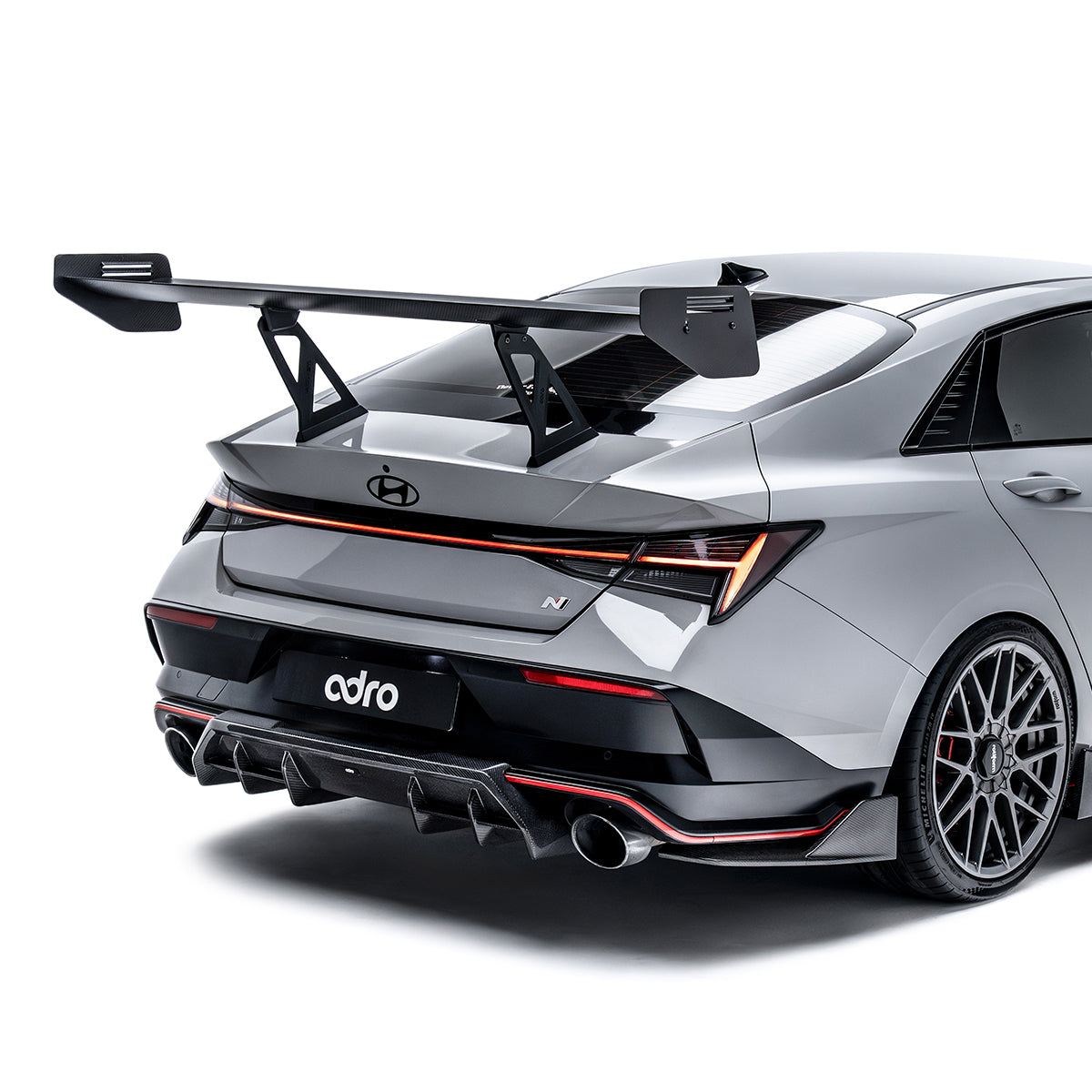 Rear diffuser side trim, black aerodynamic fins with dual exhaust outlet openings