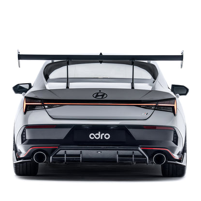 Rear diffuser insert, dark grille panel with dual exhaust openings and red trim accents