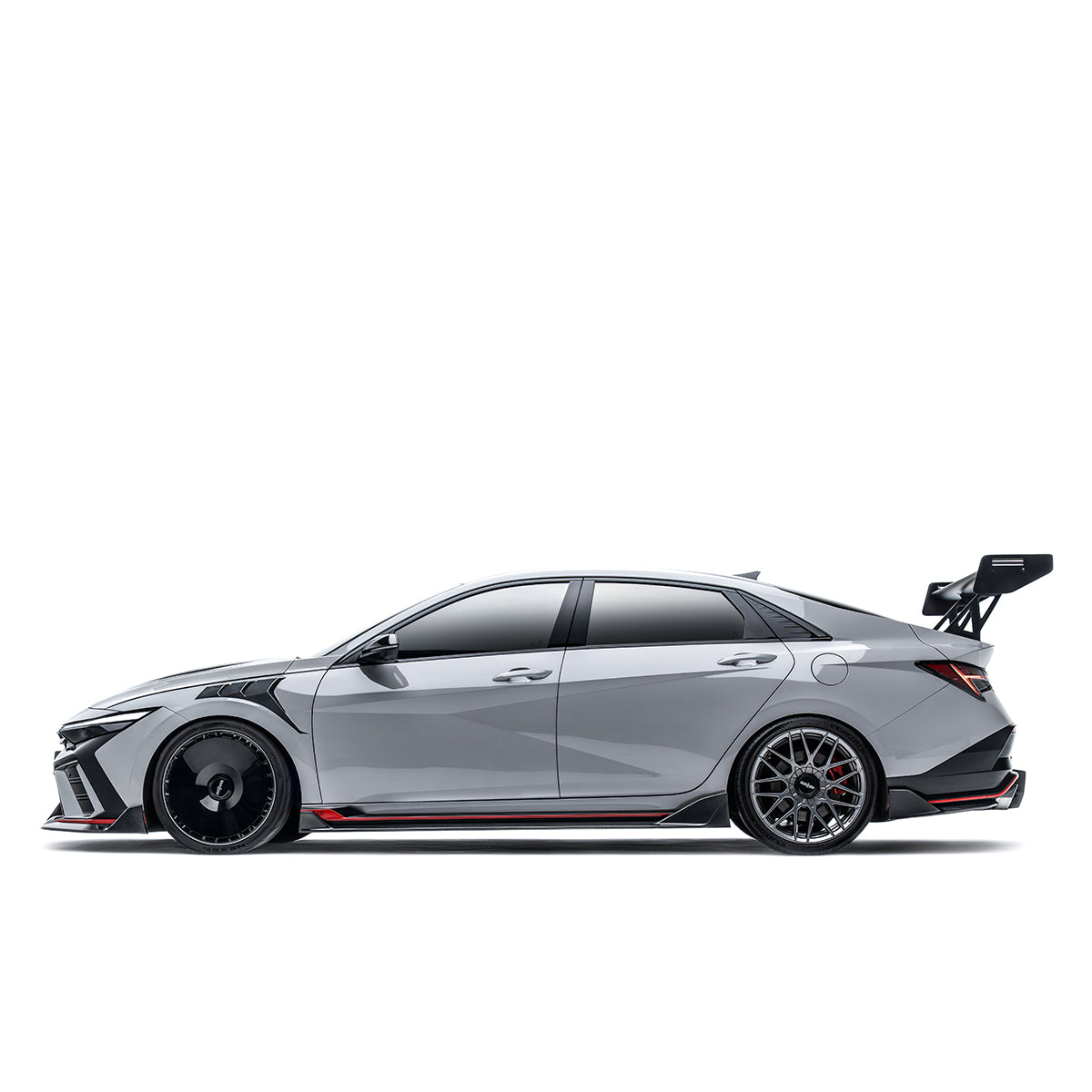 Black carbon fiber side skirt with red accent stripe on both rocker sides