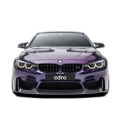 BMW front bumper lip spoiler in dark carbon fiber, front view on purple car